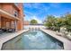 Stunning in-ground pool reflecting the sky and surrounded by lush landscaping, and covered patio at 383 Remington Dr, Oviedo, FL 32765