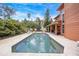 Backyard pool with adjacent covered patio and wood paneled home exterior at 383 Remington Dr, Oviedo, FL 32765