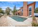 Beautiful backyard pool surrounded by lush greenery, an outdoor kitchen, and covered patio perfect for entertaining at 383 Remington Dr, Oviedo, FL 32765