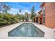 Backyard pool surrounded by lush greenery, with outdoor seating and entertainment area, perfect for relaxation at 383 Remington Dr, Oviedo, FL 32765