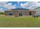 The backyard has a lush lawn and solar panels on the house at 3971 Guernsey Bnd, St Cloud, FL 34772