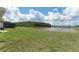 Lush backyard with a tranquil view of the lake at 3971 Guernsey Bnd, St Cloud, FL 34772