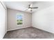 Bedroom with window view, neutral paint and carpet flooring at 3971 Guernsey Bnd, St Cloud, FL 34772