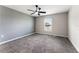 This spacious bedroom features neutral paint, plush carpeting, and a modern ceiling fan at 3971 Guernsey Bnd, St Cloud, FL 34772
