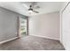 Bedroom with neutral paint, carpet flooring, and window with views at 3971 Guernsey Bnd, St Cloud, FL 34772