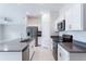 Modern kitchen featuring stainless steel appliances, white cabinets, and a large island with sink at 3971 Guernsey Bnd, St Cloud, FL 34772