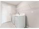 Laundry room with a washer, dryer, and wire shelving at 3971 Guernsey Bnd, St Cloud, FL 34772