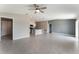Open living area with tile floors, ceiling fan, and access to the kitchen with bar seating at 3971 Guernsey Bnd, St Cloud, FL 34772