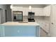 Well-equipped kitchen with stainless steel appliances, white cabinets, modern countertops, and an island at 475 Marion Oaks Mnr, Ocala, FL 34473