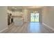 Modern open kitchen and living area with stainless steel appliances and an island featuring a sliding glass door at 475 Marion Oaks Mnr, Ocala, FL 34473