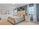 Serene main bedroom with a tufted headboard, side tables, lamps and decorative wall hangings at 4908 Kaia Ave, Winter Haven, FL 33884