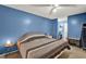 This spacious bedroom features blue walls, a ceiling fan, and an ensuite bathroom at 513 Dew Drop Cv, Casselberry, FL 32707
