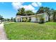 Single-story home with green lawn and mature landscaping creating great curb appeal at 513 Dew Drop Cv, Casselberry, FL 32707
