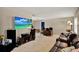 Living room with neutral walls, carpet flooring and a large entertainment center at 513 Dew Drop Cv, Casselberry, FL 32707
