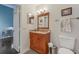 Nicely appointed bathroom with wood vanity, granite countertop, and traditional fixtures at 6057 Lake Pointe Dr # 408, Orlando, FL 32822