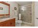 Stylish bathroom featuring a glass enclosed shower, vanity with a granite counter, and modern lighting at 6057 Lake Pointe Dr # 408, Orlando, FL 32822