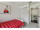 Well-lit bedroom featuring a twin bed, neutral paint, closet, and a decorative painting at 6057 Lake Pointe Dr # 408, Orlando, FL 32822