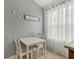 An intimate dining area featuring a small table set near a bright window at 6057 Lake Pointe Dr # 408, Orlando, FL 32822