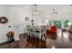 Charming dining area offering dark wood floors, contemporary lighting, and an adjacent living room perfect for gatherings at 6057 Lake Pointe Dr # 408, Orlando, FL 32822