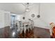 Cozy dining room with dark wood floors, and modern lighting, adjacent to a cozy living area, perfect for Gathering meals at 6057 Lake Pointe Dr # 408, Orlando, FL 32822