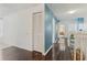 Upstairs hallway featuring dark wood floors, crisp white trim, and a pop of color for an inviting transition between rooms at 6057 Lake Pointe Dr # 408, Orlando, FL 32822