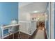 Bright upstairs hallway with dark wood floors leads to living spaces offering a seamless flow throughout the home at 6057 Lake Pointe Dr # 408, Orlando, FL 32822