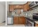 A well-lit kitchen featuring stainless steel appliances, mosaic tile backsplash, and granite countertops at 6057 Lake Pointe Dr # 408, Orlando, FL 32822