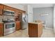 A modern kitchen with stainless steel appliances, granite countertops and warm, wood cabinetry at 6057 Lake Pointe Dr # 408, Orlando, FL 32822