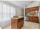 Eat-in kitchen with island, stainless appliances, granite counters, tile floors and large window at 6057 Lake Pointe Dr # 408, Orlando, FL 32822
