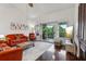 Stylish living room boasting dark wood floors, vaulted ceiling, and natural light streaming through sliding glass doors at 6057 Lake Pointe Dr # 408, Orlando, FL 32822