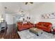 Bright living room featuring dark wood floors, plush seating, and a vaulted ceiling creating a cozy and inviting space at 6057 Lake Pointe Dr # 408, Orlando, FL 32822