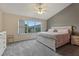 A bright and airy main bedroom showcasing a large window with views and a neutral color palette at 6057 Lake Pointe Dr # 408, Orlando, FL 32822