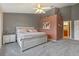 A spacious main bedroom with a unique accent wall and an attached bathroom at 6057 Lake Pointe Dr # 408, Orlando, FL 32822