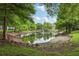 Lush trees frame this serene pond with a fountain, creating a peaceful and picturesque natural setting at 6057 Lake Pointe Dr # 408, Orlando, FL 32822