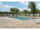 A refreshing pool area is surrounded by mature landscaping and lounge chairs, perfect for relaxation and recreation at 6057 Lake Pointe Dr # 408, Orlando, FL 32822