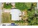 Aerial view of the house shows its roof, driveway, and backyard shaded by trees at 633 E Church Ave, Longwood, FL 32750
