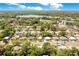 Expansive aerial view of homes surrounded by lush trees with a beautiful lake nearby at 633 E Church Ave, Longwood, FL 32750