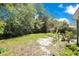 Green backyard provides privacy with mature trees, and space for relaxing at 633 E Church Ave, Longwood, FL 32750