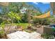 Charming backyard offers a shaded seating area and a lush green lawn, perfect for relaxation at 633 E Church Ave, Longwood, FL 32750