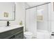 Modern bathroom with a stylish vanity, sleek mirror, and a combined shower and tub at 633 E Church Ave, Longwood, FL 32750