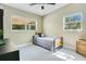 Simple bedroom with a single bed, two bright windows, and minimalist decor at 633 E Church Ave, Longwood, FL 32750