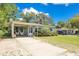 Lovely single-story home featuring a covered parking area and well-maintained landscaping at 633 E Church Ave, Longwood, FL 32750
