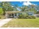 Charming single-story home with a covered parking area and well-maintained landscaping at 633 E Church Ave, Longwood, FL 32750