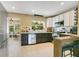 Modern kitchen with white cabinets, stainless steel appliances, and a breakfast bar at 633 E Church Ave, Longwood, FL 32750