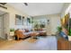 Inviting living room with neutral walls, a comfortable sofa, and a bright window at 633 E Church Ave, Longwood, FL 32750