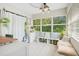 Bright sun room features large windows, modern lighting, built in storage, and comfortable seating at 633 E Church Ave, Longwood, FL 32750