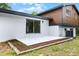 A simple patio extends from the back of the home to a patch of mulch at 7085 Willowwood St, Orlando, FL 32818