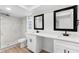 Bathroom featuring double vanity with sleek black fixtures and a glass-enclosed shower at 7085 Willowwood St, Orlando, FL 32818
