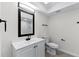 Modern bathroom featuring sleek vanity with dark fixtures and a well-lit mirror at 7085 Willowwood St, Orlando, FL 32818