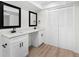Updated bathroom boasts double vanity with sleek black fixtures and ample storage space at 7085 Willowwood St, Orlando, FL 32818
